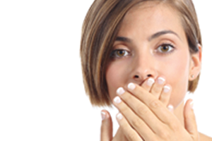 Woman hiding her mouth because she has bad breath