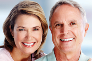 Man and woman with healthy, white smiles