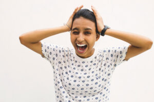 woman grabbing head and stressing out