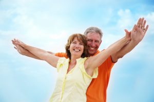 Older couple smiling with dentures