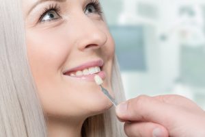 Woman receiving porcelain veneers