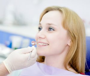 Woman being examined before receiving tooth-colored fillings