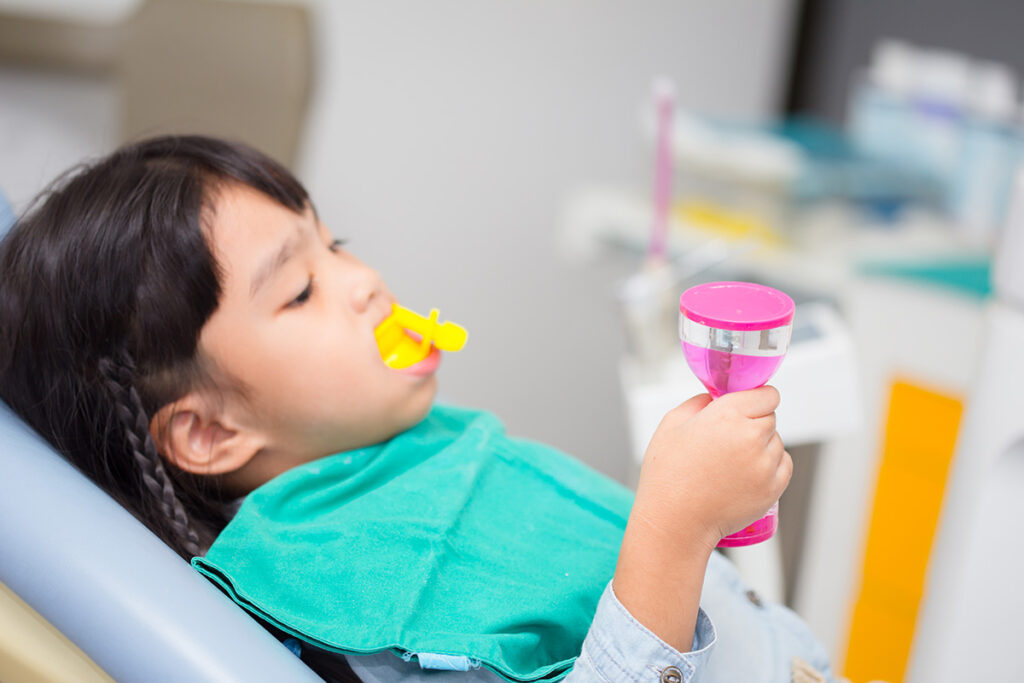 Little girl receiving a fluoride treatment at Cobblestone Park Family Dental in Oklahoma City