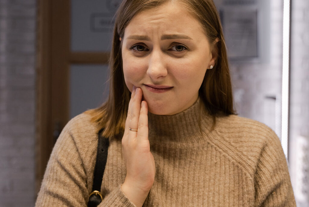 Woman with a dental emergency visiting Cobblestone Park Family Dental