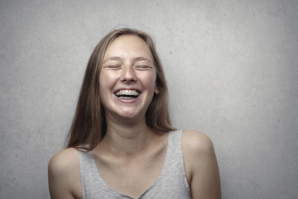 A girl smiles with braces